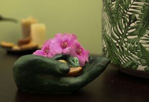 Buddha hand with flowers in Julie's Freshwater massage clinic